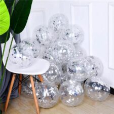 Clear confetti-filled balloons with silver foil confetti stacked on floor