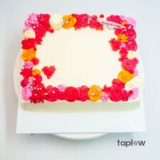 Single white rose wrapped in blue paper with greenery