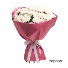 Bouquet of mixed pastel roses in pink and cream shades wrapped in paper
