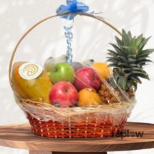 Mixed fruit basket with pineapple, apples and mango