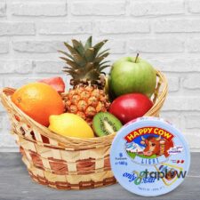 Fruit basket with pineapple, apple, orange and a can of condensed milk in front.