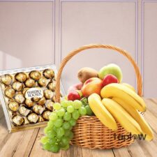Fruit basket arrangement with grapes, bananas and a Ferrero Rocher chocolate box.