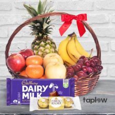 Fruit gift basket with pineapple, bananas, grapes and Cadbury Dairy Milk with Ferrero rocher.