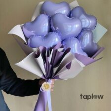 Small blue Stitch plush toy held by model