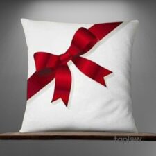 White cushion with printed red ribbon bow design