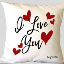 White cushion with Love You script and red hearts
