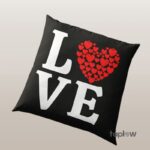 Black cushion with “LOVE” text and red heart motif