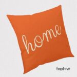 Orange cushion with home script text