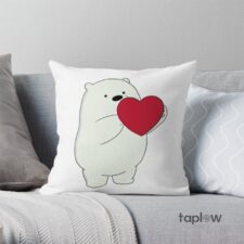 White cushion with cartoon polar bear holding red heart