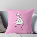 Pink cushion with finger-heart hand illustration