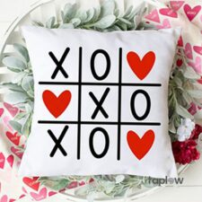 White cushion with tic-tac-toe hearts grid (X O hearts)