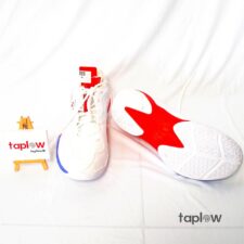 White sneakers with red sole and accent details (pair) product shot.