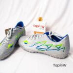 Grey and green football shoes (pair) on white background (product image).