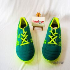 Green youth soccer shoes with neon details (pair) product photo.