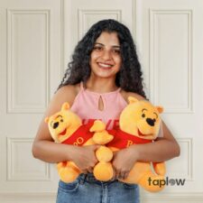 Round chocolate birthday cake with cream swirls and decorative toppings