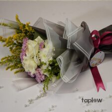Wrapped mixed flower bouquet with pale pink and cream blooms