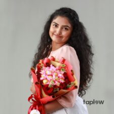 Woman holding red and pink rose bouquet wrapped
