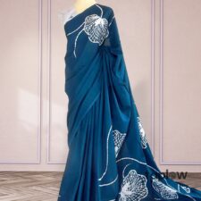 Teal blue saree with white floral print on mannequin