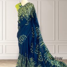 Dark blue saree with green sequin embellishments on mannequin
